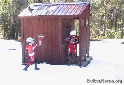 02 Bryan and Briana throw snowballs near the outhouse
