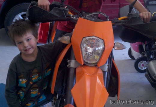 Ezra and Anthony on the KTM in the garage